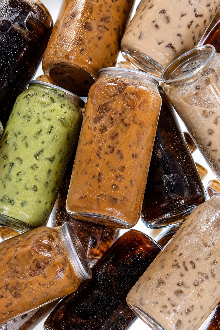 Top-down collage of iced coffee drinks in clear glasses arranged edge to edge